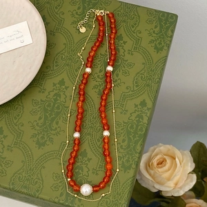 Vintage layered necklace with chalcedony beads and white pearls on a floral gift box