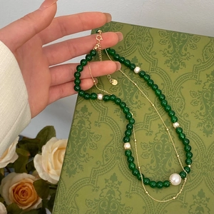 Double-layer necklace featuring green chalcedony beads and white natural pearls on a gold chain