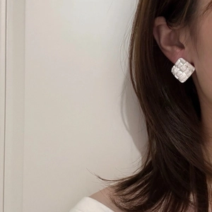 Textured silver square stud earrings with woven pattern on model for an elegant look