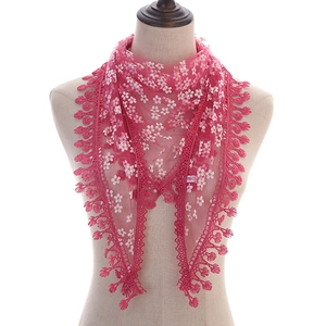 Detailed view of breathable lace triangular scarf with floral patterns and fringe