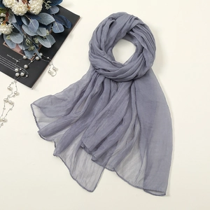 Close-up of grey chiffon scarf with rolled edges and lightweight translucent texture