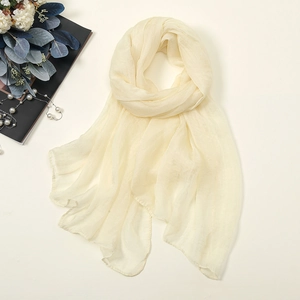 Flat lay of light yellow 30D chiffon scarf with pearls and floral prop details