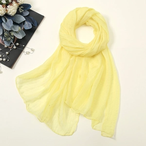 Macro detail of vibrant yellow 30D chiffon scarf texture and translucent fabric weave