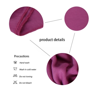 Detail of purple jersey fabric texture with overlock stitching and care instructions