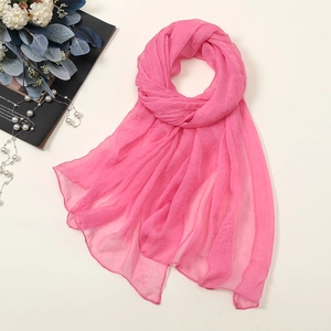 Detail shot of bright pink 30D chiffon scarf with lightweight and textured fabric finish