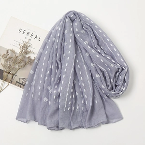 Detail shot of lavender linen scarf with white polka dots and star patterns