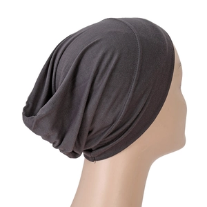 Detail view of dark grey modal turban cap showing elastic knitted fabric and soft pleats