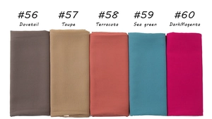 Flat lay of multiple breathable pearl chiffon hijabs in various solid earthy colors