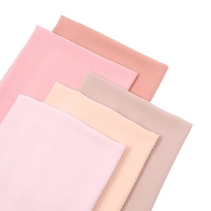 Stack of four solid pearl chiffon hijabs in soft Morandi colors on a white background