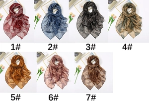 Collage of lightweight scarfs in seven colors with geometric patterns and props