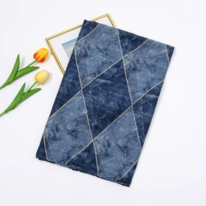 Detail of dark blue geometric diamond pattern scarf with marble texture on white background
