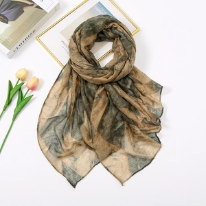 Detail view of lightweight geometric pattern scarf with artistic magazine and tulips
