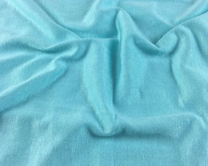 Close-up of light blue modal knit fabric showing soft texture and fine ribbed details