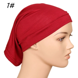Detail view of deep red modal hijab cap with pleated back design on mannequin head