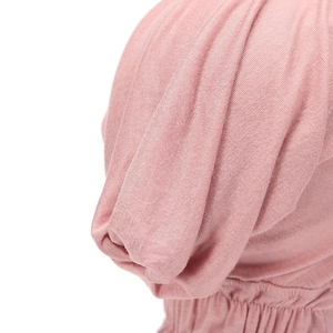 Macro shot of pink modal jersey hijab cap showing soft fabric texture and elastic stitching