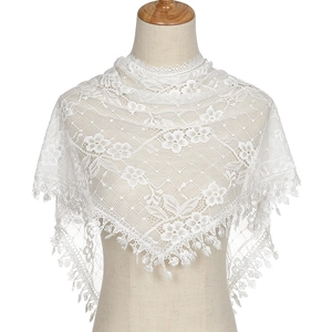 Close-up of elegant white floral lace triangle shawl with delicate tassel fringe