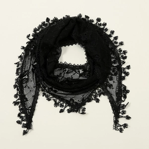 Close-up of elegant black floral lace triangle scarf with delicate tassel edges