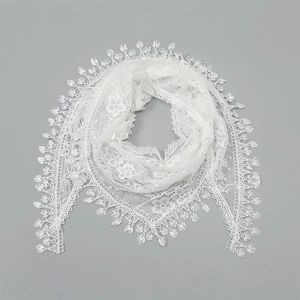 Detailed view of white floral lace triangle scarf with delicate water drop tassel edges