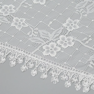 Elegant white floral lace triangle scarf with delicate mesh pattern and tassel trim edge