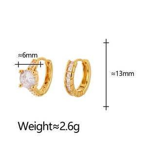 Detail view of gold huggie earrings with a 6mm cubic zirconia and 13mm height