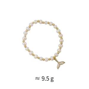 Detail of freshwater pearl bracelet featuring a sparkling crystal-encrusted fish tail charm