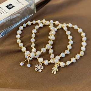 Elegant freshwater pearl bracelets with gold beads and sparkling crystal pendants