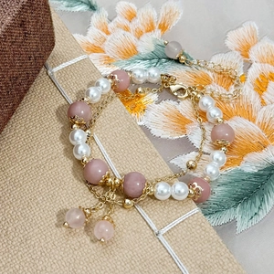 Pink natural stone and pearl layered bracelet with golden flower charms and chain