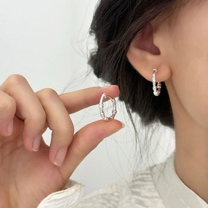 Minimalist irregular silver hoop earrings with a textured surface for a refined look