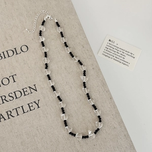 Elegant beaded necklace with black round pearls and transparent glass hearts for women