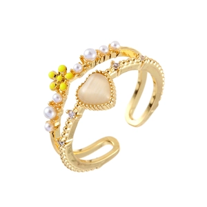Detail of gold double-layer open ring featuring a yellow flower and heart opal stone