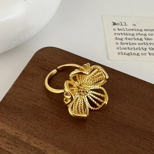 Elegant gold hollow flower statement open ring with vintage textured petals and luxury style