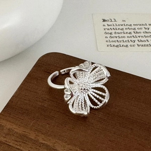 Detailed close-up of hollow flower ring petals with fine mesh texture and S925 stamp
