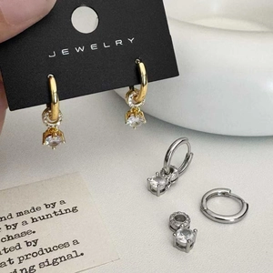 Macro view of vintage-style zircon drop earrings in gold and silver plated finish