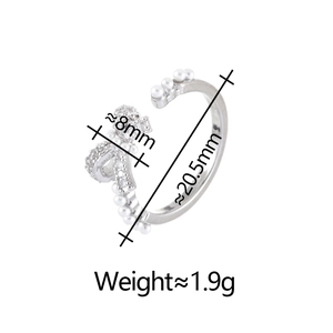 Detail view of adjustable bow ring with small pearls and crystals and size dimensions