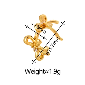 Detail shot of golden bow ear cuff with clear zircon and dimensions 15.7mm by 12mm