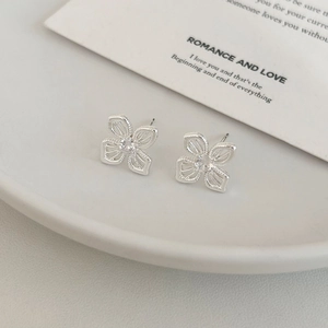 Minimalist silver floral stud earrings with sparkling zircon stones in hollow flower design