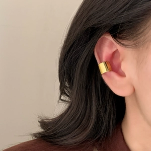 Minimalist wide gold ear cuff with mirror finish shown on a model for a chic look