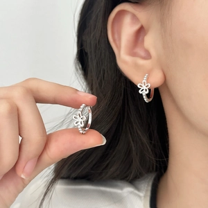 Elegant silver daisy hoop earrings with hollow flower petals and white zircon stones