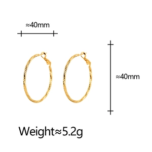 Minimalist gold hoop earrings with textured geometric pattern and 40mm diameter