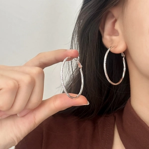 Silver geometric textured hoop earrings with slanted engraved patterns for women