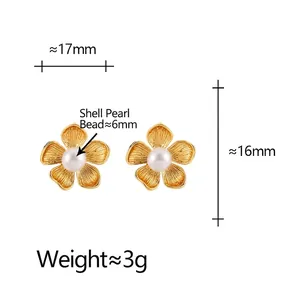Elegant gold flower stud earrings with shell pearls featuring brushed metal texture