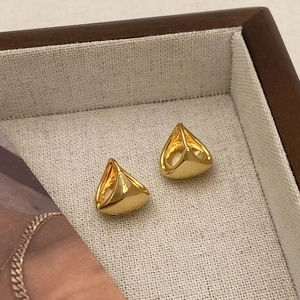 Minimalist gold geometric hollow earrings displayed on a premium wooden jewelry tray