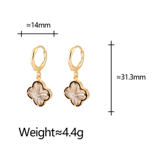 Detailed view of gold hoop earrings with black enamel clover and zircon inlays