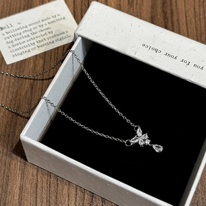 Detailed view of a silver butterfly pendant with teardrop zircon in a premium gift box