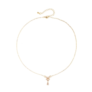 Elegant gold necklace with butterfly pendant and pear-shaped zircon on white background