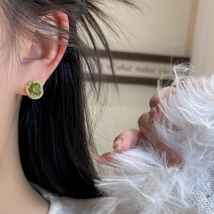 Retro emerald green zircon earrings with gold plating shown on model for elegant look
