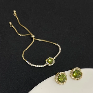 Vintage jewelry set with green zircon stones and gold finish bracelet and earrings