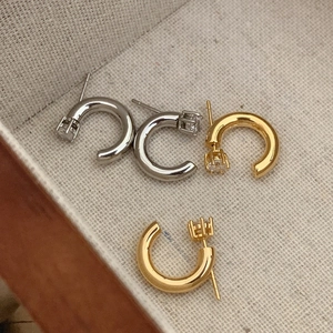 Elegant C-shaped stud earrings in gold and silver finish with sparkling zircon stones