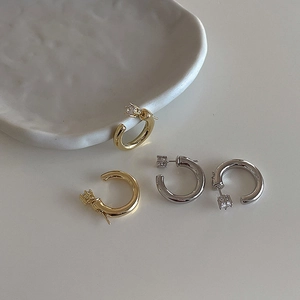 Minimalist C-shaped hoop earrings in gold and silver finish with sparkling zircon stones