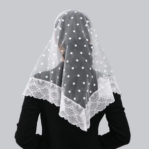 Detailed view of bridal lace veil with polka dot mesh and scalloped floral edge
